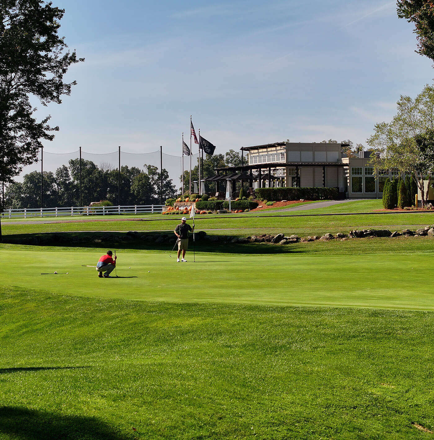 golfers on the green by clubhouse